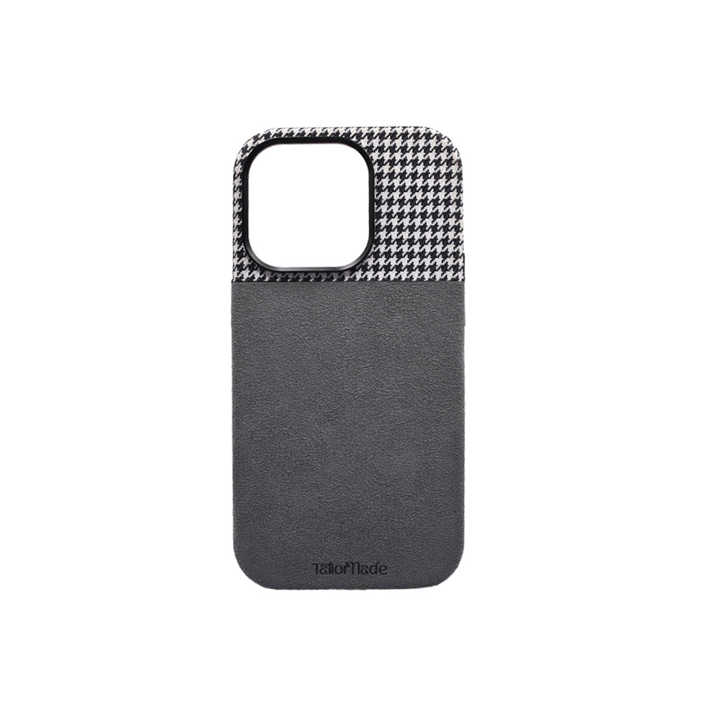 A phone case with a houndstooth pattern on the top and a solid color on the bottom, predominantly in a black and gray color palette.