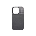 A phone case with a houndstooth pattern on the top and a solid color on the bottom, predominantly in a black and gray color palette.
