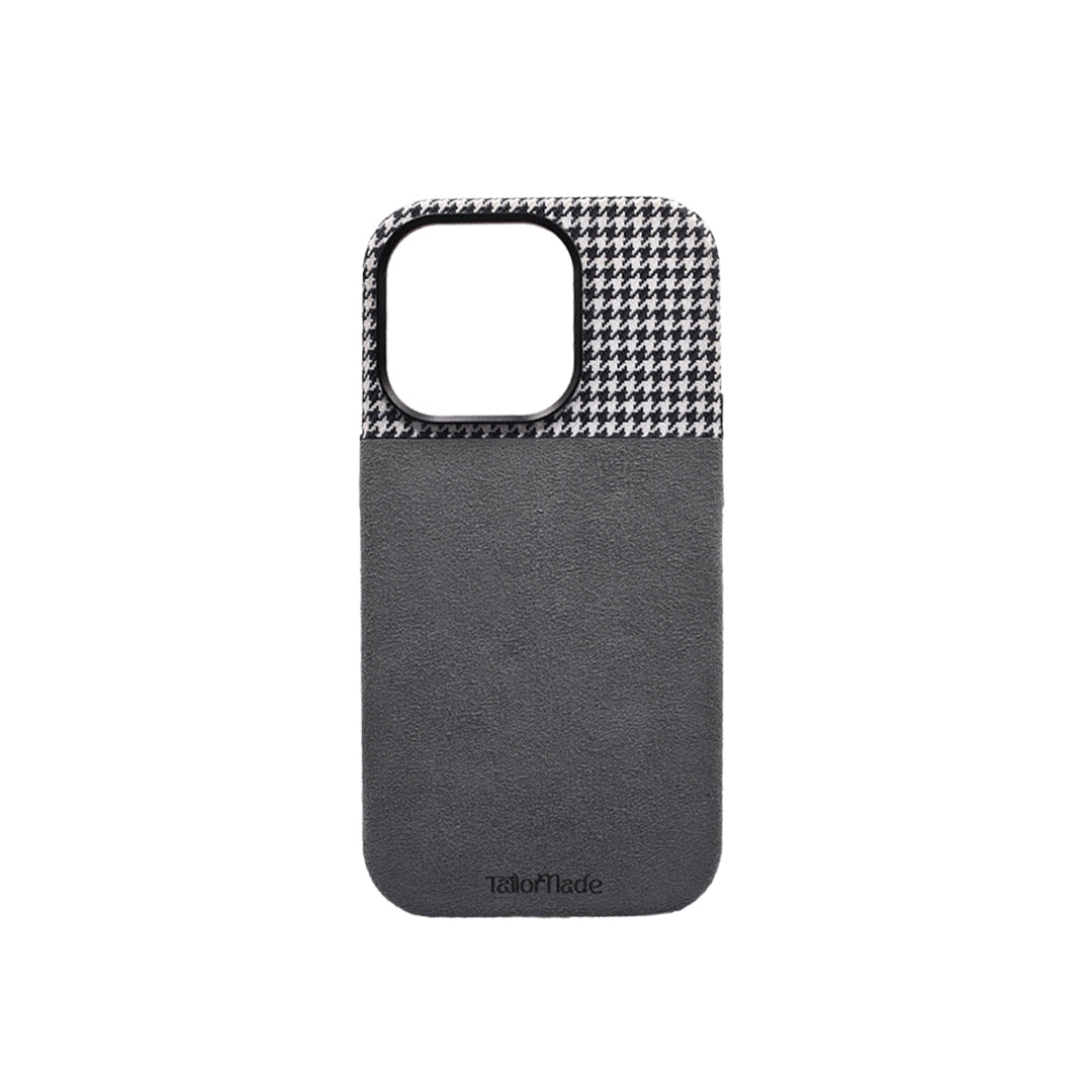 A phone case with a houndstooth pattern on the top and a solid color on the bottom, predominantly in a black and gray color palette.